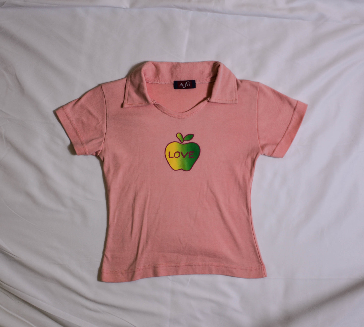 Pastel Orange Polo with Apple Graphic